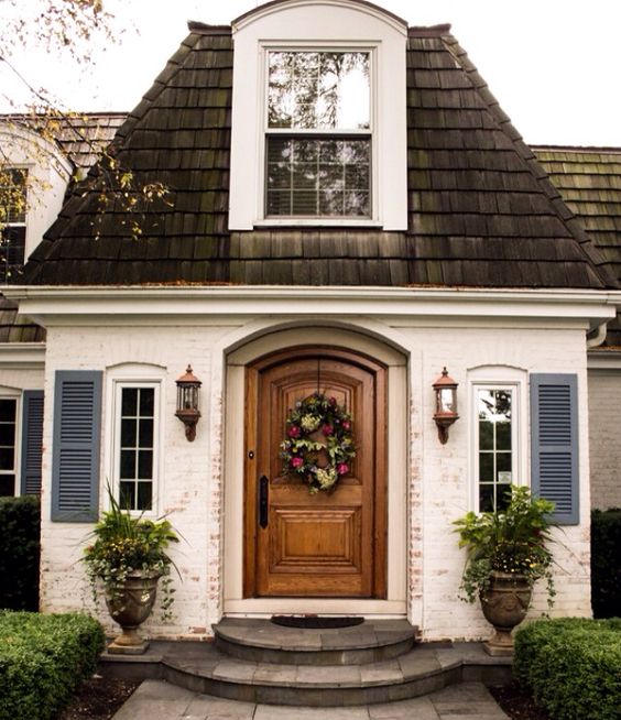 Painted louvered shutters in a country French blue give this tiny home instant curb appeal. Image from Pinterest.