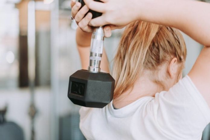 franklin athletic club woman lifting weights