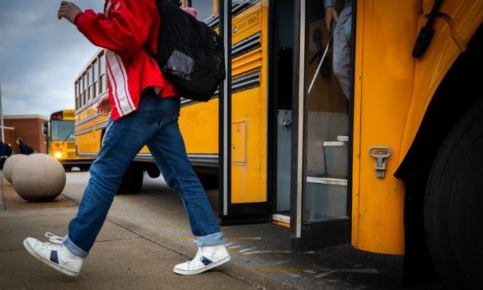 Boy Student Walking off Bus
