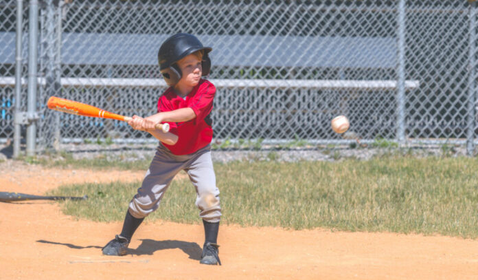 Baseball Player Swinging at Ball