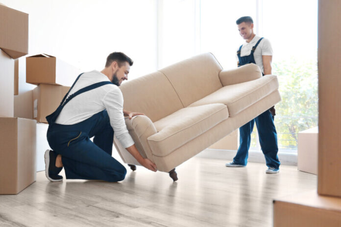 Delivery men moving sofa in room at new home Appliance and Furniture Free Delivery Local Service Tennessee